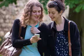two students looking at a mobile phone