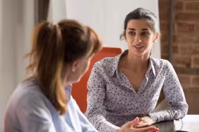 Two students talking in professional setting