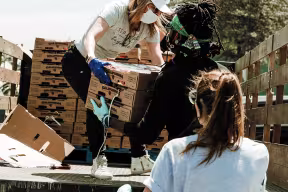 People moving boxes, working in the charity sector