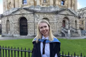 Sophia stands outside the Radcliffe Camera in sub fusc