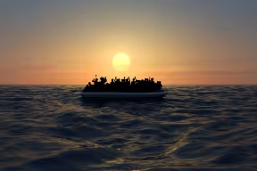 Migrants in rubber boat in the sea