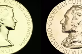 Two of the Royal Society Medals; they are gold medallions with embossed portraits of eminent scientists