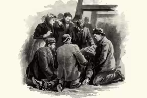 A group of adults cluster around a prostrate body of a miner brought up after an accident in a coal mine