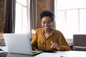 Person smiling while using computer 