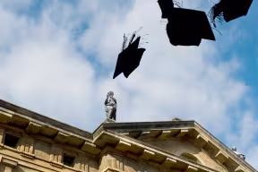 Mortar boards in the air above Sheldonian