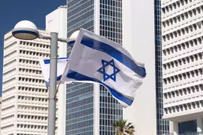  Israeli flag against modern architecture in Tel Aviv