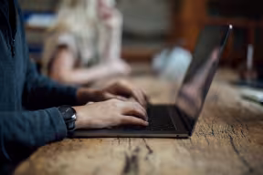 Student typing on a laptop