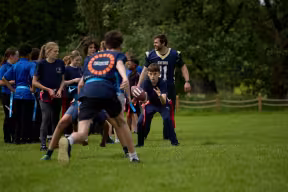 Sports Leaders Programme participants from Greyfriars school learning American Football with University of Oxford student athletes