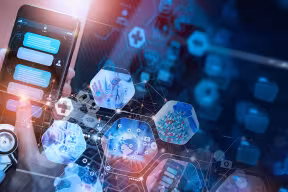 A doctor using a chatbot on a smart phone. The background has icons representing digital medicine, pills and tablets, a doctor with a stethoscope, the emergency service network, and telemedicine.