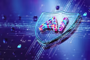Concept of an AI security system showing a shield with the word ‘AI’ embossed on it, against a circuit board-style background. 