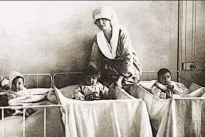 A historical photo of nurses and babies in a nursery. Image credit: Shutterstock.