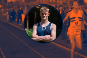 Oxford student Tom Barrett in front of an image of the historic Sir Roger Bannister running his 4-minute mile