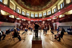 Image of Oxford Philharmonic Orchestra performing a tribute concert at the Sheldonian for the Oxford vaccine team