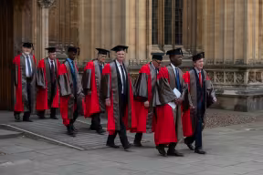 Image depicts honorands leaving the Divinity School and processing into the Sheldonian Theatre