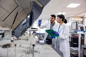 Team of scientists working at the laboratory processing samples. Credit: andresr, Getty Images  