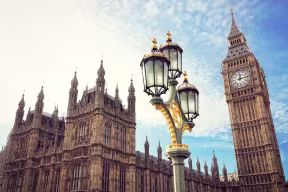 Big Ben and the houses of parliament in London, with an ornate lamppost in the foreground. 