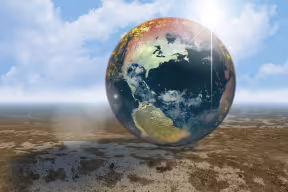 Artistic image of a world globe on deserted plain.