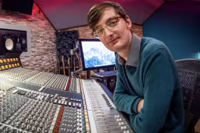 Student Matt Taylor at a recording studio desk.