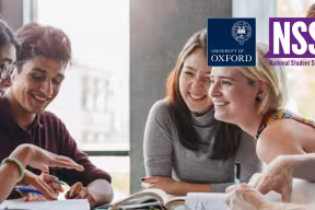 Five students sat together talking - National Student Survey