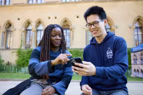 Two students looking at a phone