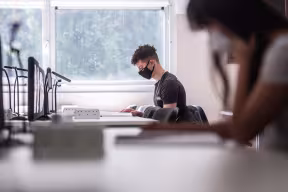 Students socially distanced studying with masks on at desks. By John Cairns.