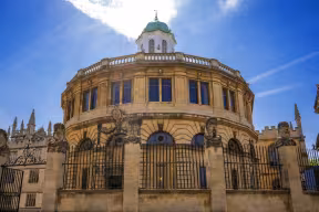 The Sheldonian Theatre at the University of Oxford: an ornate semi-circular building topped with a cupola. 