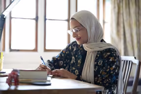 Student studying inn their college bedroom