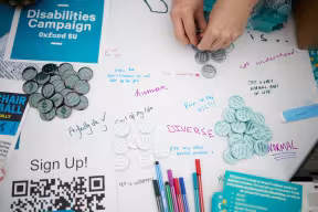 The Disabilities Campaign table at Freshers Fair, with buttons, writing, and pens