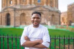 Wantoe T. Wantoe stands with arms folded in front of the Radcliffe Camera