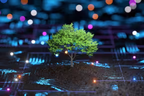 A lone tree stands amidst glowing digital lines on a dark surface.