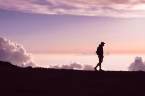 Person walking against a pinky sky | Jad Limcaco on Unsplash