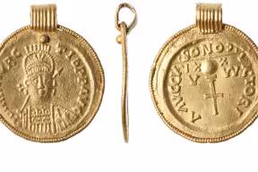 A pendant made from a Gallic Provençal quasi-Imperial gold solidus in the name of Maurice Tiberius (582-602).