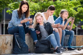 Teenagers using their smartphones