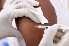 Photo | Example of a Close-up Of A Doctor Injecting Syringe To Male Patient's Arm In Clinic