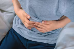 Child holding his abdomen in pain