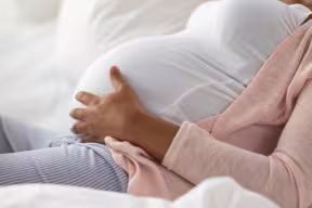 Pregnant woman holding her bump 