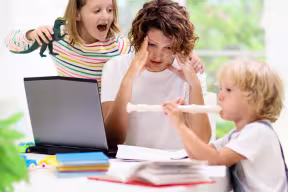 Working mother struggling to work with children at home