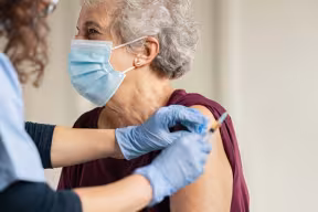 Elderly woman receiving a vaccination