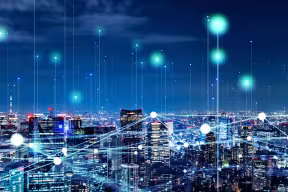 A city with lines of light connecting the buildings, to represent digital communications. Image credit: Shutterstock