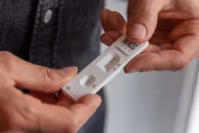 Photo | Man taking a rapid antigen test (lateral flow) for covid-19