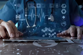 Doctor looking at touch screen of data