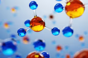 An artistic image of molecules made of a central sphere connected to four smaller spheres. Image credit: Shutterstock.
