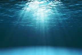 Sun shining through ocean water