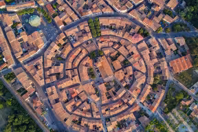 Aerial top view of Bram medieval village architecture and roofs in Southern France