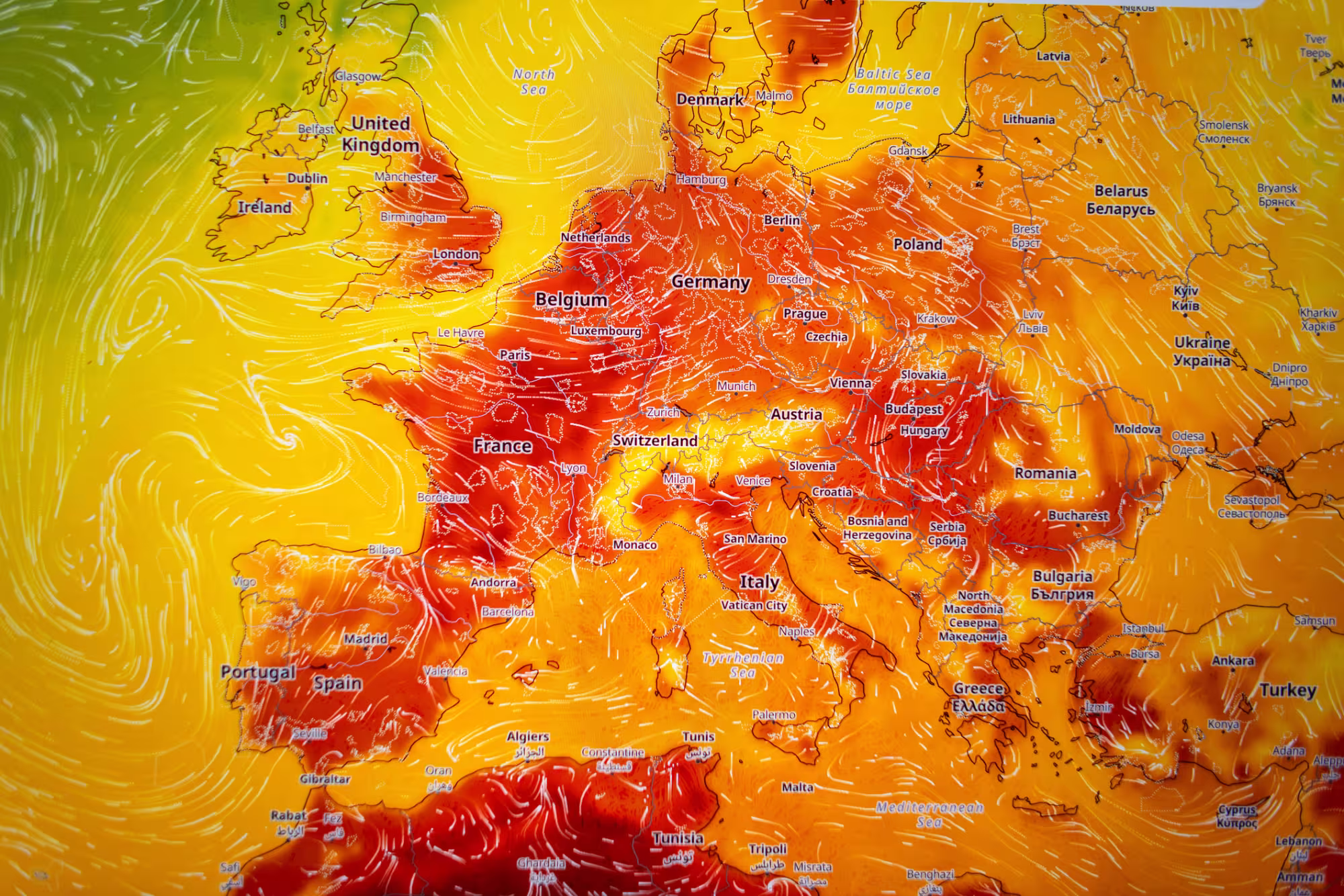  A weather forecast map of Europe covered in intense red and orange colors, symbolizing an extreme heatwave, abnormal high temperatures.