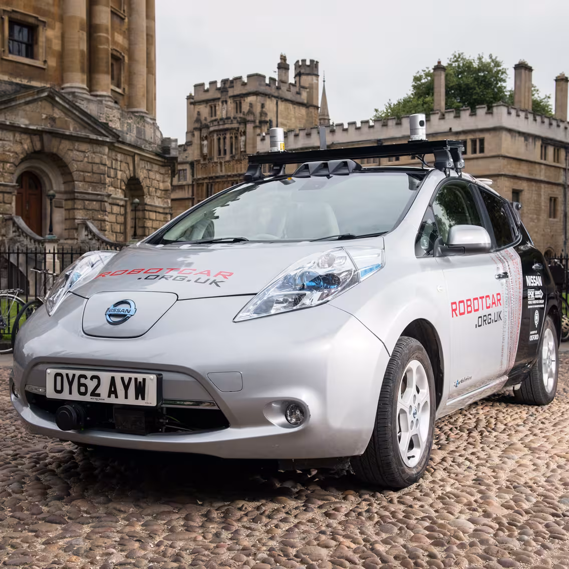 A grey Nissan car equipped with sensors on the roof, outside Blenheim Palace.